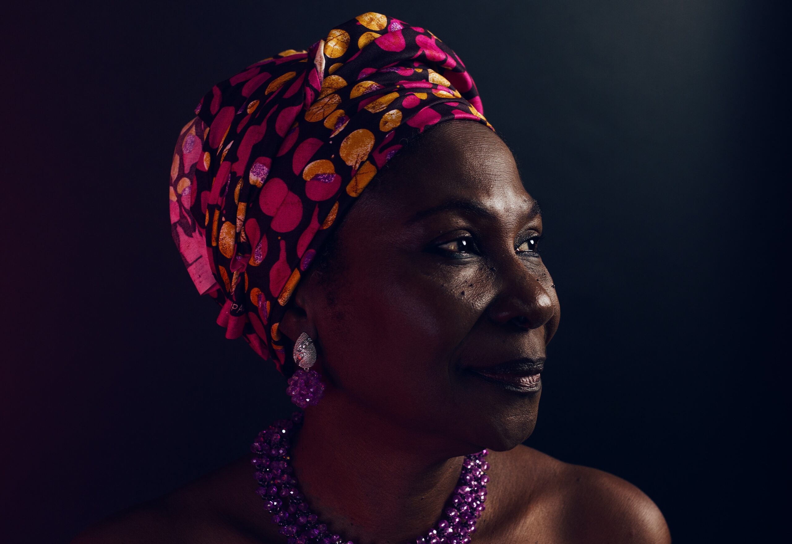 african woman in colorful head scarf